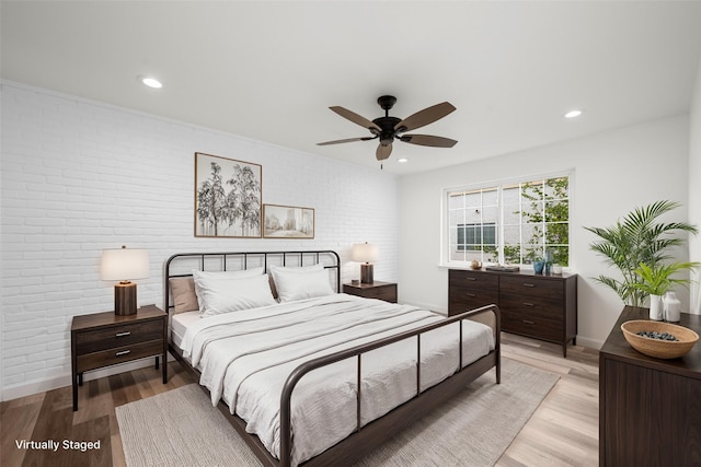 2744 Briarhurst Dr Unit 33, Houston, TX 77057 - bedroom featuring brick wall, light wood finished floors, baseboards, recessed lighting, and ceiling fan