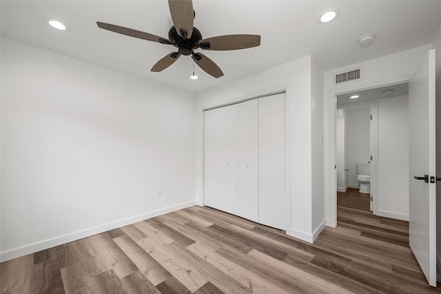 2744 Briarhurst Dr Unit 33, Houston, TX 77057 - unfurnished bedroom featuring wood finished floors, recessed lighting, a closet, baseboards, and ceiling fan