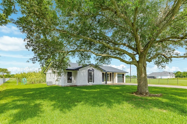 2735 County Road 208, Danbury, TX 77534 - ranch-style home with concrete driveway, an attached garage, and central AC