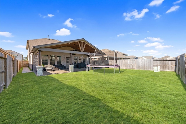 13215 Rowan Green Dr, Humble, TX 77346 - rear view of property featuring a patio, a trampoline, and roof with shingles