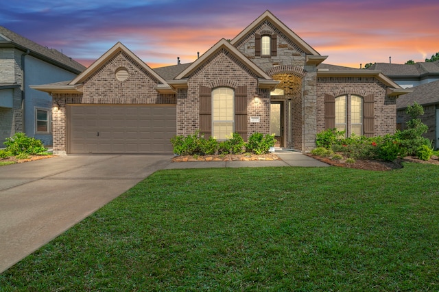 28010 Drifters Bend Dr, Spring, TX 77386 - french country inspired facade with brick siding, driveway, a yard, an attached garage, and a shingled roof