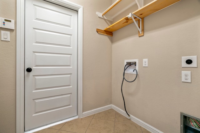 28010 Drifters Bend Dr, Spring, TX 77386 - washroom featuring hookup for an electric dryer, light tile patterned floors, hookup for a washing machine, and baseboards