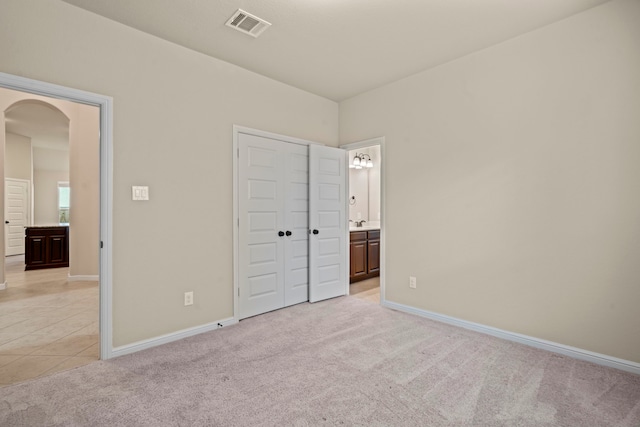28010 Drifters Bend Dr, Spring, TX 77386 - unfurnished bedroom with arched walkways, light carpet, and baseboards