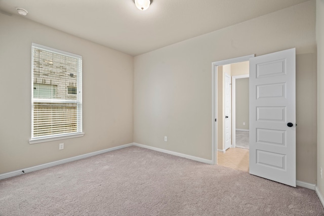 28010 Drifters Bend Dr, Spring, TX 77386 - empty room featuring light carpet, baseboards, and a smoke detector