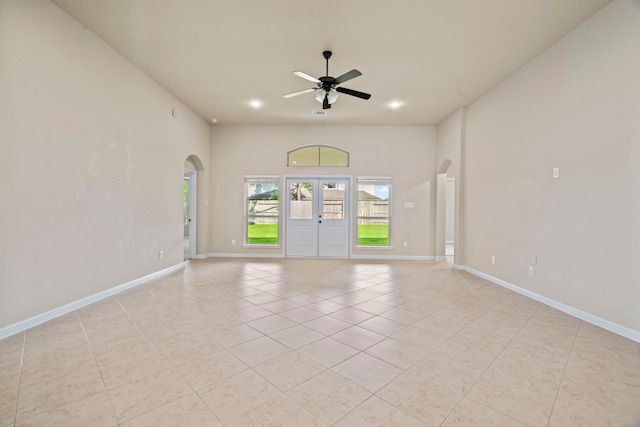 28010 Drifters Bend Dr, Spring, TX 77386 - unfurnished room featuring arched walkways, light tile patterned floors, ceiling fan, baseboards, and recessed lighting