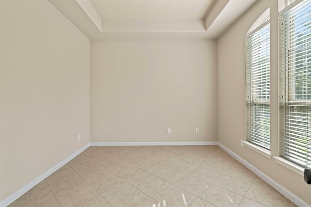 28010 Drifters Bend Dr, Spring, TX 77386 - unfurnished room with plenty of natural light, light tile patterned floors, a tray ceiling, and baseboards
