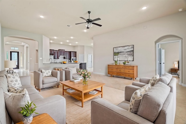 28010 Drifters Bend Dr, Spring, TX 77386 - living room with arched walkways, ceiling fan, light tile patterned floors, and recessed lighting