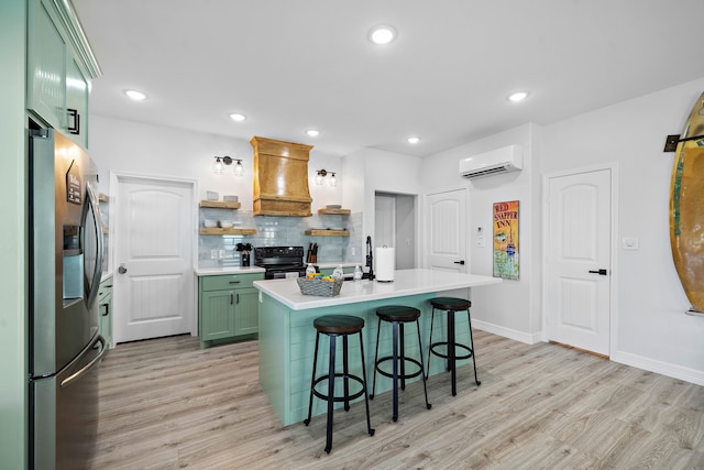 622 Crane Ct, Surfside Beach, TX 77541 - kitchen with stainless steel refrigerator with ice dispenser, green cabinets, premium range hood, a wall unit AC, and black / electric stove