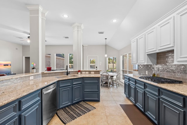 14123 Sherburn Manor Dr, Cypress, TX 77429 - kitchen featuring a sink, appliances with stainless steel finishes, decorative columns, white cabinets, and decorative backsplash