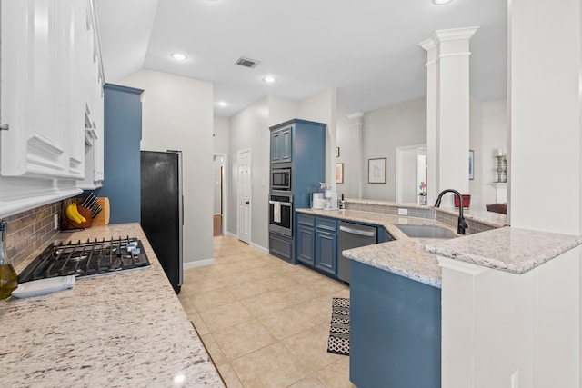 14123 Sherburn Manor Dr, Cypress, TX 77429 - kitchen with a sink, blue cabinets, stainless steel appliances, a peninsula, and decorative backsplash