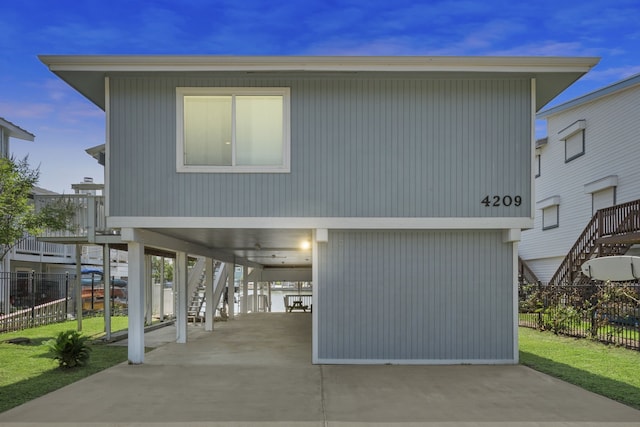 4209 W Bayside Way, Jamaica Beach, TX 77554 - view of front of house with stairway and a carport