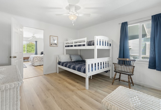 4209 W Bayside Way, Jamaica Beach, TX 77554 - bedroom with light wood-style flooring, ceiling fan, and baseboards