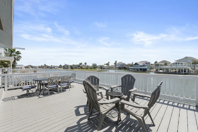 4209 W Bayside Way, Jamaica Beach, TX 77554 - wooden deck with a water view and outdoor dining area