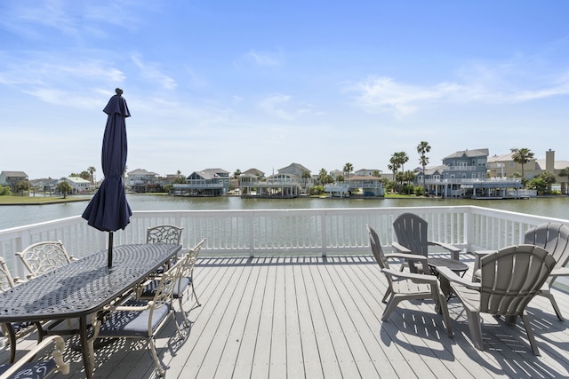 4209 W Bayside Way, Jamaica Beach, TX 77554 - wooden terrace featuring a residential view, a water view, and outdoor dining space