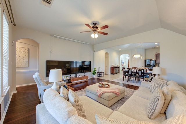 19503 Sundance Edge Ct, Richmond, TX 77407 - living area with arched walkways, wood finished floors, ceiling fan, and lofted ceiling