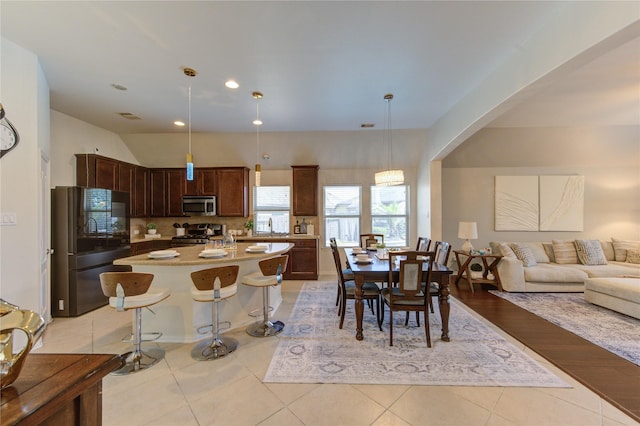 19503 Sundance Edge Ct, Richmond, TX 77407 - dining room with arched walkways, light tile patterned flooring, and recessed lighting