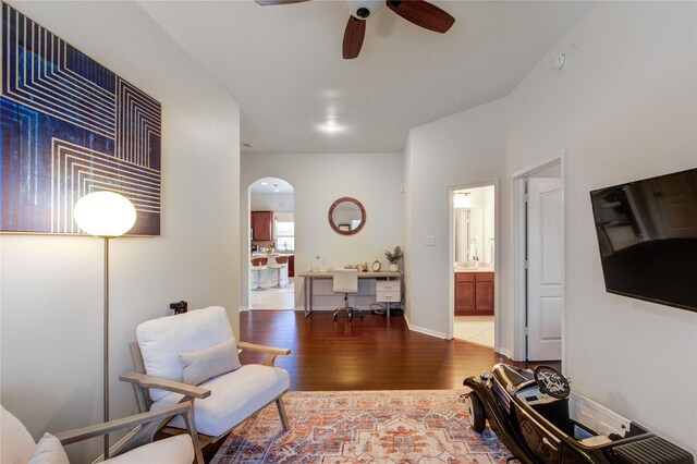 19503 Sundance Edge Ct, Richmond, TX 77407 - living area with arched walkways, wood finished floors, and ceiling fan