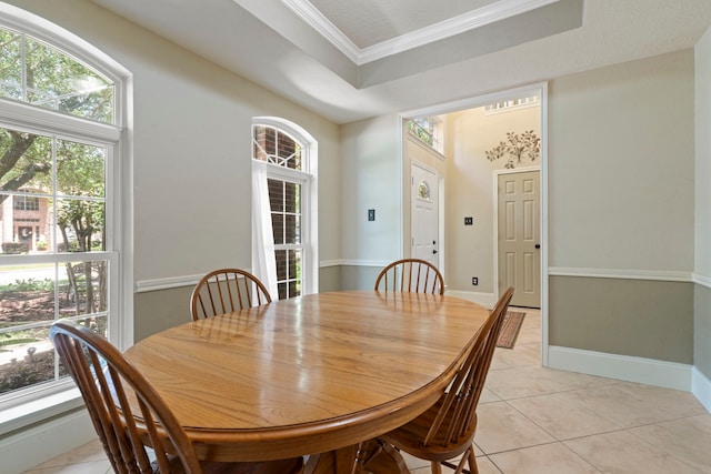 13506 Scenic Glade Dr, Houston, TX 77059 - dining area featuring a tray ceiling, crown molding, light tile patterned flooring, and baseboards