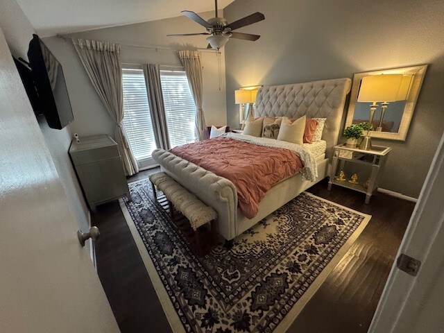 2211 S Kirkwood Rd Unit 1, Houston, TX 77077 - bedroom with lofted ceiling, wood finished floors, baseboards, and ceiling fan