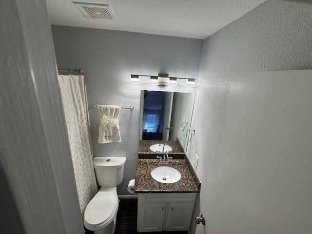 2211 S Kirkwood Rd Unit 1, Houston, TX 77077 - bathroom with vanity, a textured wall, and wood finished floors