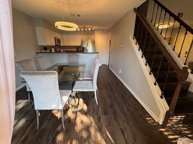 2211 S Kirkwood Rd Unit 1, Houston, TX 77077 - dining room featuring dark wood finished floors, baseboards, and stairs