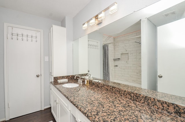 2211 S Kirkwood Rd Unit 1, Houston, TX 77077 - full bath with vanity, a tile shower, and wood finished floors