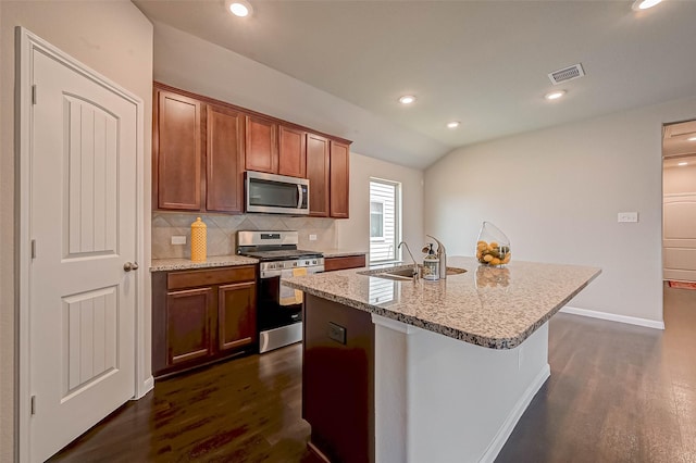21622 Sage Landing Ln, Katy, TX 77449 - kitchen with stainless steel appliances, dark wood-style floors, tasteful backsplash, vaulted ceiling, and a sink