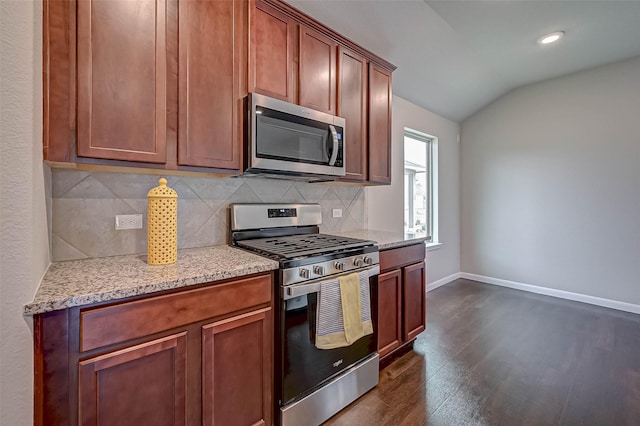 21622 Sage Landing Ln, Katy, TX 77449 - kitchen featuring stainless steel appliances, lofted ceiling, tasteful backsplash, dark wood-style flooring, and baseboards