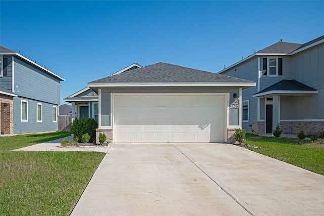 21622 Sage Landing Ln, Katy, TX 77449 - view of front facade with concrete driveway, an attached garage, a front lawn, roof with shingles, and brick siding
