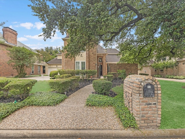 13 Hickory Shadows Dr, Houston, TX 77055 - view of front of house with a front yard, brick siding, and a garage
