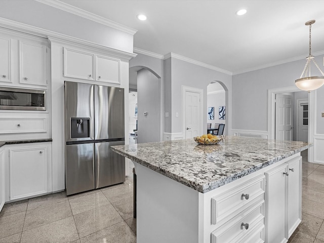 13 Hickory Shadows Dr, Houston, TX 77055 - kitchen featuring stainless steel appliances, arched walkways, crown molding, light stone counters, and white cabinetry