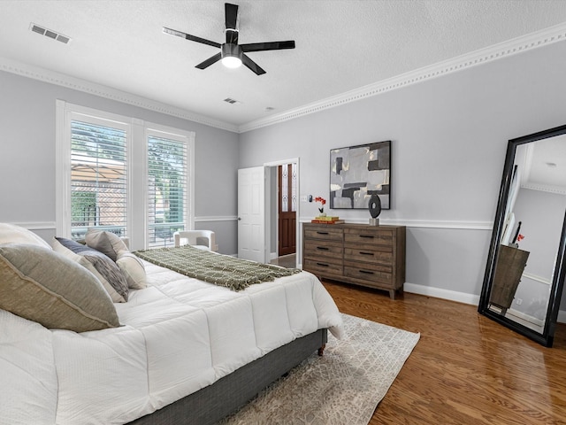 13 Hickory Shadows Dr, Houston, TX 77055 - bedroom with dark wood-style floors, ornamental molding, a textured ceiling, baseboards, and ceiling fan