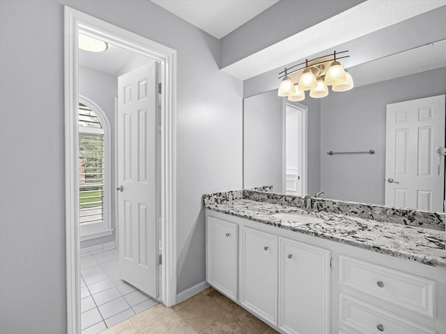 13 Hickory Shadows Dr, Houston, TX 77055 - bathroom featuring vanity, tile patterned floors, a chandelier, and baseboards