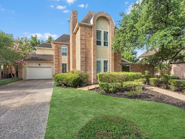 13 Hickory Shadows Dr, Houston, TX 77055 - traditional home with an attached garage, concrete driveway, a chimney, a front yard, and stucco siding