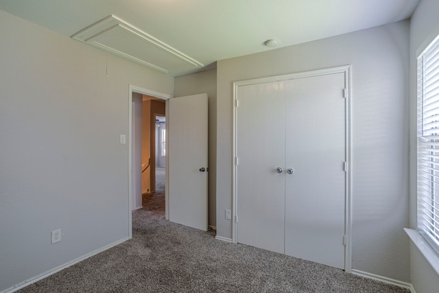 21002 Brannon Hill Ln, Humble, TX 77338 - unfurnished bedroom with attic access, carpet, and a closet