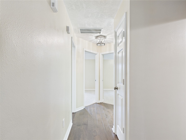 11628 King Edward Ct, Montgomery, TX 77316 - hall with dark wood-type flooring, baseboards, and a textured ceiling