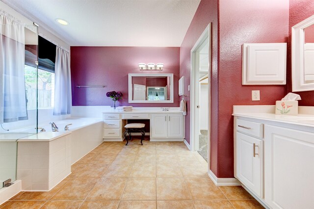 1810 Spreading Bough Ln, Richmond, TX 77406 - bathroom featuring a garden tub, vanity, tile patterned floors, and a textured wall