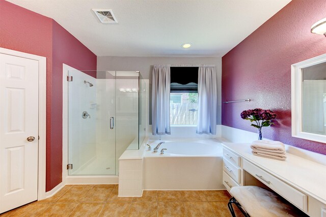 1810 Spreading Bough Ln, Richmond, TX 77406 - full bathroom with a shower stall, a bath, tile patterned floors, and a textured wall