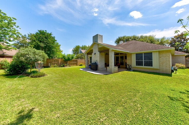 1810 Spreading Bough Ln, Richmond, TX 77406 - back of property with brick siding, a patio, a chimney, and a shingled roof