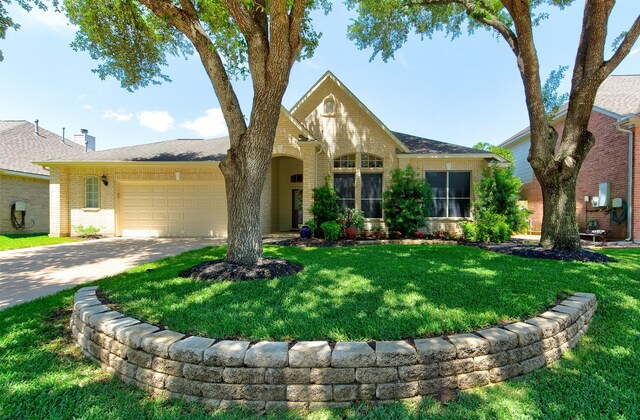 1810 Spreading Bough Ln, Richmond, TX 77406 - view of front of house with brick siding, an attached garage, driveway, and a front yard