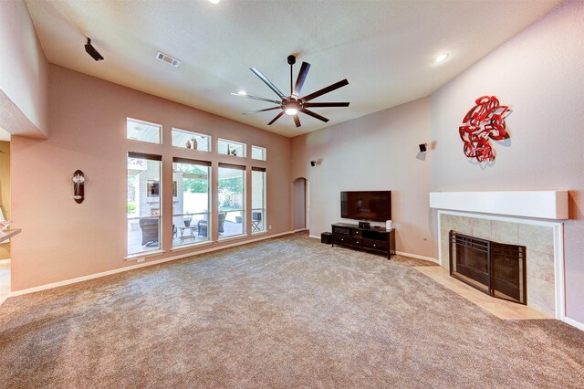1810 Spreading Bough Ln, Richmond, TX 77406 - unfurnished living room featuring a ceiling fan, a tile fireplace, carpet, recessed lighting, and arched walkways