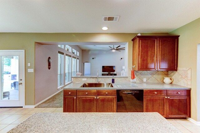 1810 Spreading Bough Ln, Richmond, TX 77406 - kitchen featuring black dishwasher, a sink, light tile patterned floors, and decorative backsplash