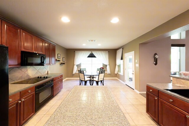 1810 Spreading Bough Ln, Richmond, TX 77406 - kitchen with black appliances, light tile patterned floors, tasteful backsplash, recessed lighting, and baseboards