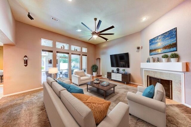 1810 Spreading Bough Ln, Richmond, TX 77406 - carpeted living room featuring a ceiling fan, a tiled fireplace, recessed lighting, and baseboards