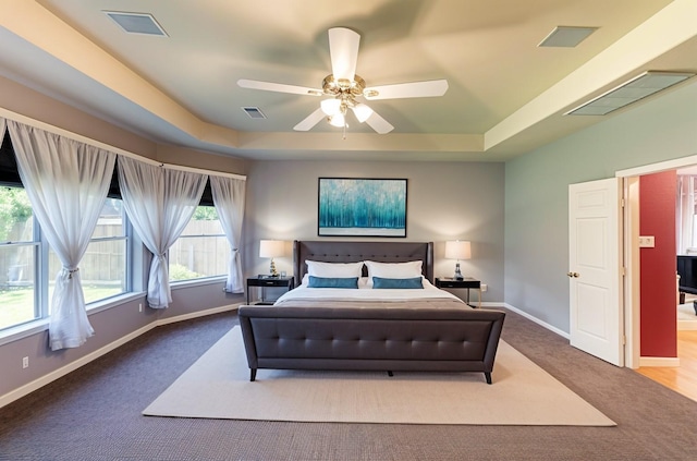 1810 Spreading Bough Ln, Richmond, TX 77406 - bedroom featuring carpet, a tray ceiling, baseboards, and ceiling fan