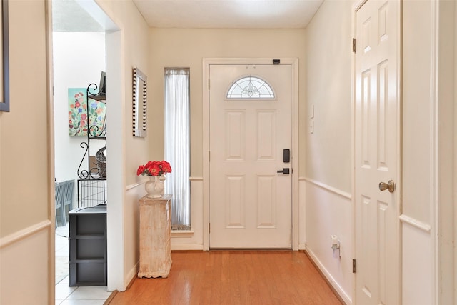 entrance foyer featuring light wood-style floors and baseboards