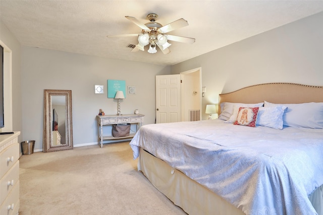 bedroom featuring light carpet, ceiling fan, and baseboards