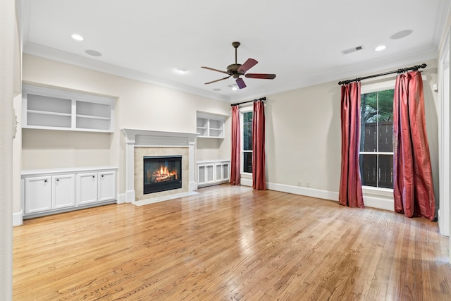 6230 Elm Heights Ln, Houston, TX 77081 - unfurnished living room with ceiling fan, light wood finished floors, a fireplace with flush hearth, ornamental molding, and baseboards