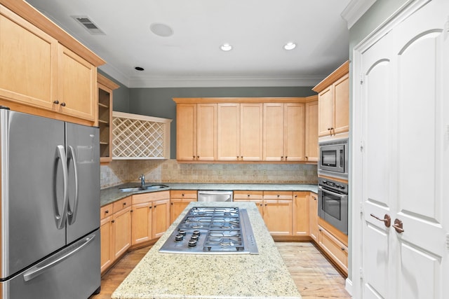 6230 Elm Heights Ln, Houston, TX 77081 - kitchen featuring appliances with stainless steel finishes, light brown cabinets, a sink, crown molding, and light wood-style flooring