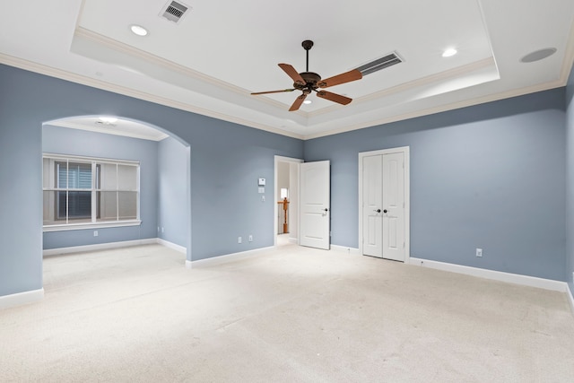 6230 Elm Heights Ln, Houston, TX 77081 - unfurnished bedroom featuring a tray ceiling, carpet, ornamental molding, arched walkways, and baseboards